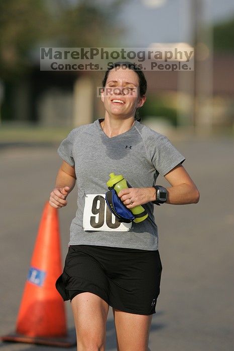 Beth Marek won first place in her age division at the Army Dillo half-marathon and 32K race.

Filename: SRM_20080921_0841403.jpg
Aperture: f/4.0
Shutter Speed: 1/2000
Body: Canon EOS-1D Mark II
Lens: Canon EF 300mm f/2.8 L IS