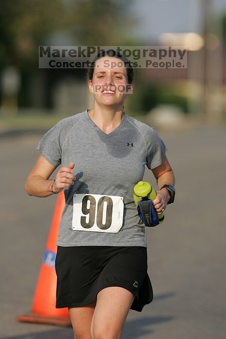 Beth Marek won first place in her age division at the Army Dillo half-marathon and 32K race.

Filename: SRM_20080921_0841404.jpg
Aperture: f/4.0
Shutter Speed: 1/2000
Body: Canon EOS-1D Mark II
Lens: Canon EF 300mm f/2.8 L IS