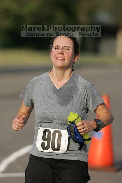 Beth Marek won first place in her age division at the Army Dillo half-marathon and 32K race.

Filename: SRM_20080921_0841429.jpg
Aperture: f/4.0
Shutter Speed: 1/2000
Body: Canon EOS-1D Mark II
Lens: Canon EF 300mm f/2.8 L IS