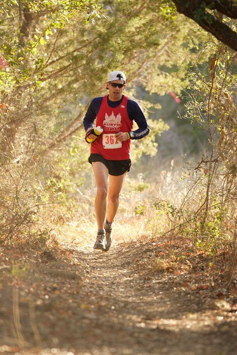 Paul Terranova placed first in his age group, fourth overall in the 25K at the Bandera 25K, 50K, and 100K trail race in Bandera, TX on Saturday, January 10, 2009.

Filename: SRM_20090110_09020435.jpg
Aperture: f/2.8
Shutter Speed: 1/400
Body: Canon EOS-1D Mark II
Lens: Canon EF 300mm f/2.8 L IS