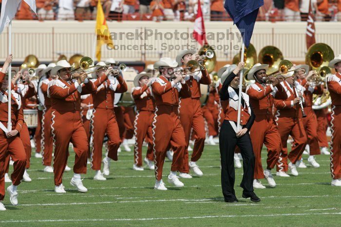 The UT marching band takes the field before the Arkansas football game.  The University of Texas football team defeated the Arkansas Razorbacks with a score of 52-10 in Austin, TX on Saturday, September 27, 2008.

Filename: SRM_20080927_14193413.jpg
Aperture: f/5.6
Shutter Speed: 1/1600
Body: Canon EOS-1D Mark II
Lens: Canon EF 300mm f/2.8 L IS