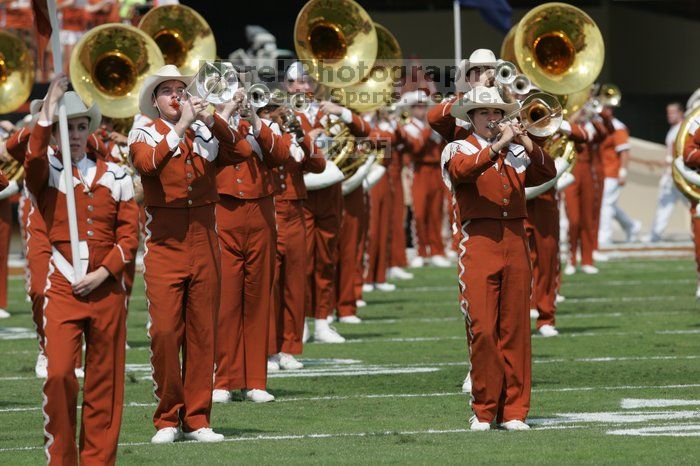 The UT marching band takes the field before the Arkansas football game.  The University of Texas football team defeated the Arkansas Razorbacks with a score of 52-10 in Austin, TX on Saturday, September 27, 2008.

Filename: SRM_20080927_14200423.jpg
Aperture: f/5.6
Shutter Speed: 1/1600
Body: Canon EOS-1D Mark II
Lens: Canon EF 300mm f/2.8 L IS