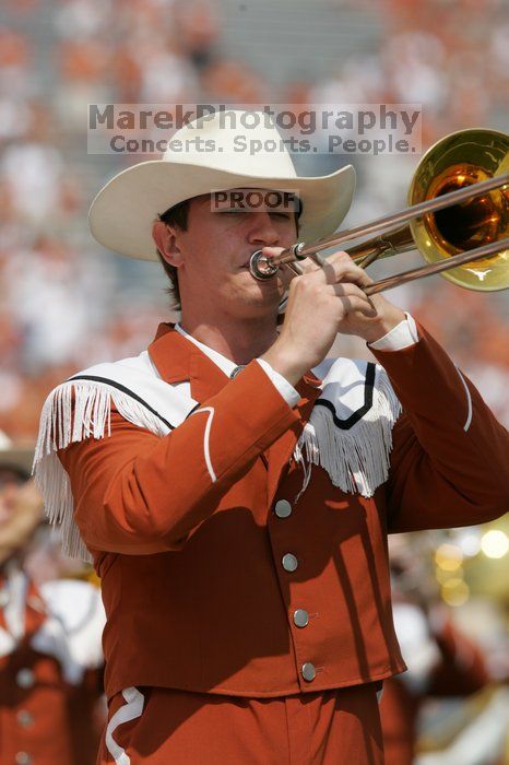 The UT marching band takes the field before the Arkansas football game.  The University of Texas football team defeated the Arkansas Razorbacks with a score of 52-10 in Austin, TX on Saturday, September 27, 2008.

Filename: SRM_20080927_14202427.jpg
Aperture: f/5.6
Shutter Speed: 1/1600
Body: Canon EOS-1D Mark II
Lens: Canon EF 300mm f/2.8 L IS