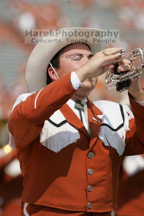 The UT marching band takes the field before the Arkansas football game.  The University of Texas football team defeated the Arkansas Razorbacks with a score of 52-10 in Austin, TX on Saturday, September 27, 2008.

Filename: SRM_20080927_14202830.jpg
Aperture: f/5.6
Shutter Speed: 1/1600
Body: Canon EOS-1D Mark II
Lens: Canon EF 300mm f/2.8 L IS