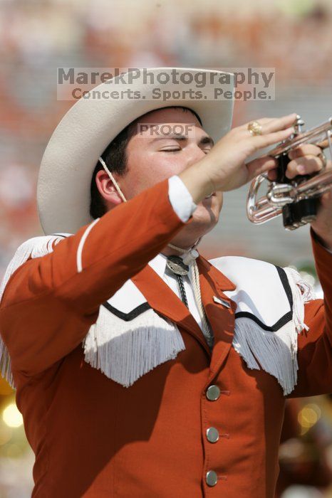 The UT marching band takes the field before the Arkansas football game.  The University of Texas football team defeated the Arkansas Razorbacks with a score of 52-10 in Austin, TX on Saturday, September 27, 2008.

Filename: SRM_20080927_14203032.jpg
Aperture: f/5.6
Shutter Speed: 1/1600
Body: Canon EOS-1D Mark II
Lens: Canon EF 300mm f/2.8 L IS