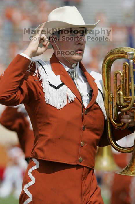 The UT marching band takes the field before the Arkansas football game.  The University of Texas football team defeated the Arkansas Razorbacks with a score of 52-10 in Austin, TX on Saturday, September 27, 2008.

Filename: SRM_20080927_14203637.jpg
Aperture: f/5.6
Shutter Speed: 1/1600
Body: Canon EOS-1D Mark II
Lens: Canon EF 300mm f/2.8 L IS