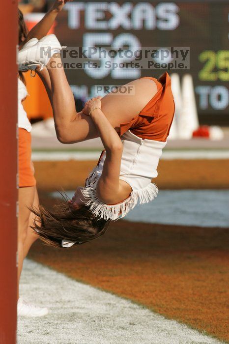 Texas Cheerleaders.  The University of Texas football team defeated the Arkansas Razorbacks with a score of 52-10 in Austin, TX on Saturday, September 27, 2008.

Filename: SRM_20080927_17193033.jpg
Aperture: f/5.6
Shutter Speed: 1/2000
Body: Canon EOS-1D Mark II
Lens: Canon EF 300mm f/2.8 L IS