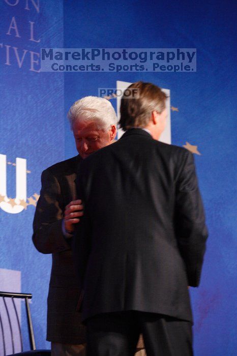 Former President Bill Clinton welcomes UT President William Powers Jr. to the stage.  Day one of the 2nd Annual Clinton Global Initiative University (CGIU) meeting was held at The University of Texas at Austin, Friday, February 13, 2009.

Filename: SRM_20090213_16293141.jpg
Aperture: f/4.0
Shutter Speed: 1/125
Body: Canon EOS-1D Mark II
Lens: Canon EF 80-200mm f/2.8 L