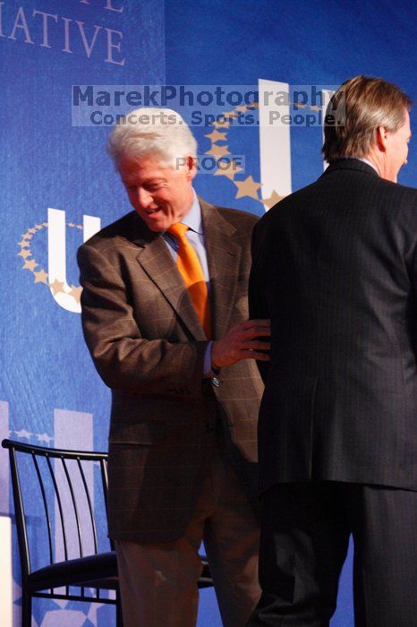 Former President Bill Clinton welcomes UT President William Powers Jr. to the stage.  Day one of the 2nd Annual Clinton Global Initiative University (CGIU) meeting was held at The University of Texas at Austin, Friday, February 13, 2009.

Filename: SRM_20090213_16293142.jpg
Aperture: f/4.0
Shutter Speed: 1/125
Body: Canon EOS-1D Mark II
Lens: Canon EF 80-200mm f/2.8 L