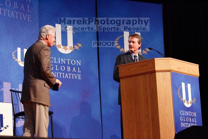 Former President Bill Clinton welcomes UT President William Powers Jr. to the stage.  Day one of the 2nd Annual Clinton Global Initiative University (CGIU) meeting was held at The University of Texas at Austin, Friday, February 13, 2009.

Filename: SRM_20090213_16294047.jpg
Aperture: f/4.0
Shutter Speed: 1/125
Body: Canon EOS-1D Mark II
Lens: Canon EF 80-200mm f/2.8 L