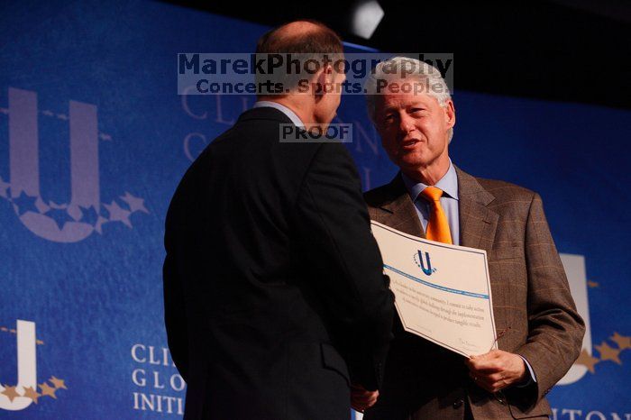 Former President Bill Clinton hands out commitment certificates to CGIU attendees for their exceptional pledges to the CGI cause during the opening plenary session of the CGIU meeting.  Day one of the 2nd Annual Clinton Global Initiative University (CGIU) meeting was held at The University of Texas at Austin, Friday, February 13, 2009.

Filename: SRM_20090213_16401441.jpg
Aperture: f/4.0
Shutter Speed: 1/200
Body: Canon EOS-1D Mark II
Lens: Canon EF 80-200mm f/2.8 L