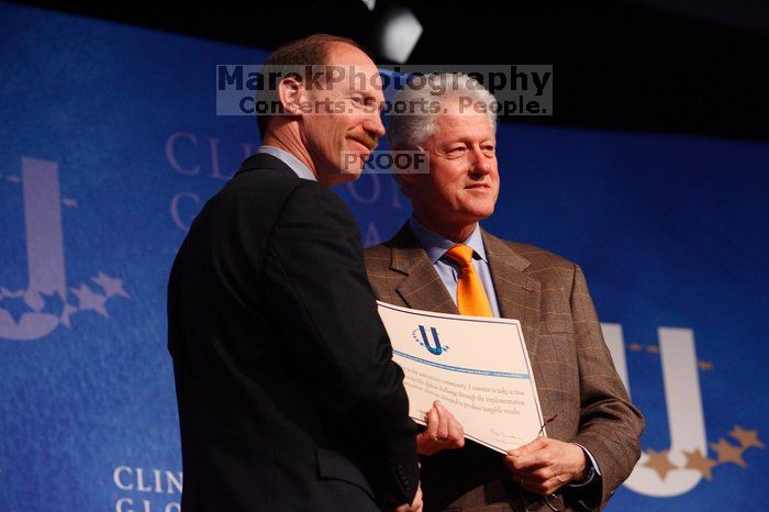 Former President Bill Clinton hands out commitment certificates to CGIU attendees for their exceptional pledges to the CGI cause during the opening plenary session of the CGIU meeting.  Day one of the 2nd Annual Clinton Global Initiative University (CGIU) meeting was held at The University of Texas at Austin, Friday, February 13, 2009.

Filename: SRM_20090213_16401946.jpg
Aperture: f/4.0
Shutter Speed: 1/160
Body: Canon EOS-1D Mark II
Lens: Canon EF 80-200mm f/2.8 L