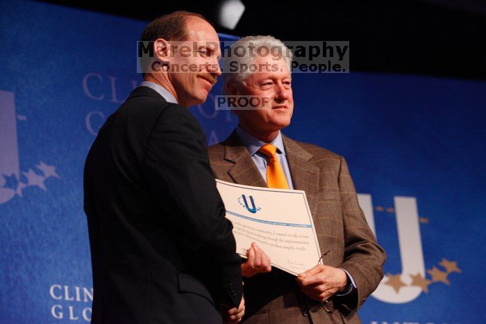 Former President Bill Clinton hands out commitment certificates to CGIU attendees for their exceptional pledges to the CGI cause during the opening plenary session of the CGIU meeting.  Day one of the 2nd Annual Clinton Global Initiative University (CGIU) meeting was held at The University of Texas at Austin, Friday, February 13, 2009.

Filename: SRM_20090213_16401947.jpg
Aperture: f/4.0
Shutter Speed: 1/160
Body: Canon EOS-1D Mark II
Lens: Canon EF 80-200mm f/2.8 L