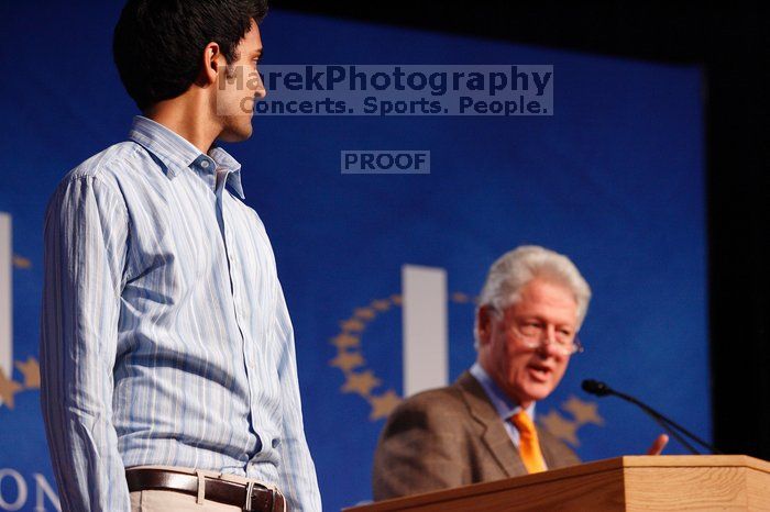 Former President Bill Clinton hands out commitment certificates to CGIU attendees for their exceptional pledges to the CGI cause during the opening plenary session of the CGIU meeting.  Day one of the 2nd Annual Clinton Global Initiative University (CGIU) meeting was held at The University of Texas at Austin, Friday, February 13, 2009.

Filename: SRM_20090213_16423972.jpg
Aperture: f/4.0
Shutter Speed: 1/125
Body: Canon EOS-1D Mark II
Lens: Canon EF 80-200mm f/2.8 L