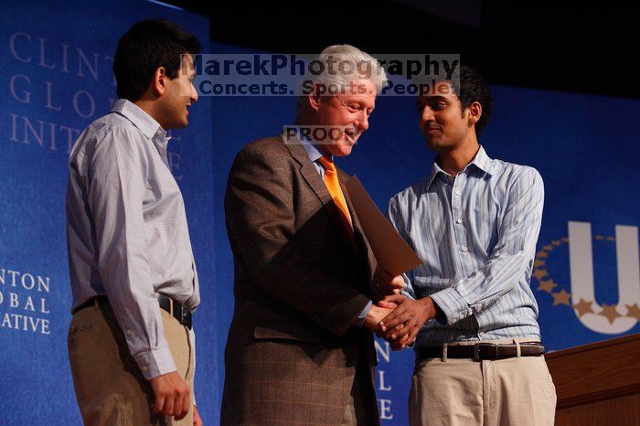 Former President Bill Clinton hands out commitment certificates to CGIU attendees for their exceptional pledges to the CGI cause during the opening plenary session of the CGIU meeting.  Day one of the 2nd Annual Clinton Global Initiative University (CGIU) meeting was held at The University of Texas at Austin, Friday, February 13, 2009.

Filename: SRM_20090213_16425282.jpg
Aperture: f/4.0
Shutter Speed: 1/200
Body: Canon EOS-1D Mark II
Lens: Canon EF 80-200mm f/2.8 L