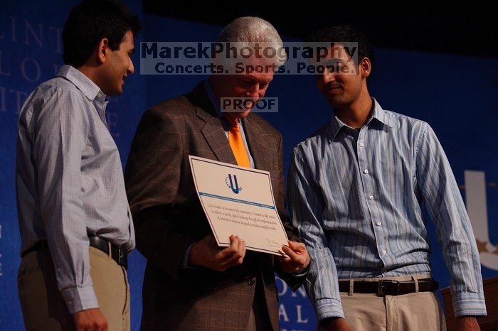 Former President Bill Clinton hands out commitment certificates to CGIU attendees for their exceptional pledges to the CGI cause during the opening plenary session of the CGIU meeting.  Day one of the 2nd Annual Clinton Global Initiative University (CGIU) meeting was held at The University of Texas at Austin, Friday, February 13, 2009.

Filename: SRM_20090213_16425384.jpg
Aperture: f/4.0
Shutter Speed: 1/320
Body: Canon EOS-1D Mark II
Lens: Canon EF 80-200mm f/2.8 L