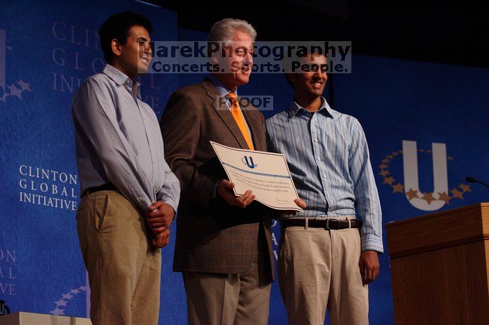 Former President Bill Clinton hands out commitment certificates to CGIU attendees for their exceptional pledges to the CGI cause during the opening plenary session of the CGIU meeting.  Day one of the 2nd Annual Clinton Global Initiative University (CGIU) meeting was held at The University of Texas at Austin, Friday, February 13, 2009.

Filename: SRM_20090213_16425788.jpg
Aperture: f/4.0
Shutter Speed: 1/320
Body: Canon EOS-1D Mark II
Lens: Canon EF 80-200mm f/2.8 L