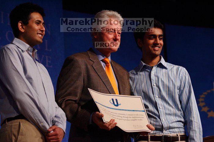 Former President Bill Clinton hands out commitment certificates to CGIU attendees for their exceptional pledges to the CGI cause during the opening plenary session of the CGIU meeting.  Day one of the 2nd Annual Clinton Global Initiative University (CGIU) meeting was held at The University of Texas at Austin, Friday, February 13, 2009.

Filename: SRM_20090213_16430091.jpg
Aperture: f/4.0
Shutter Speed: 1/250
Body: Canon EOS-1D Mark II
Lens: Canon EF 80-200mm f/2.8 L