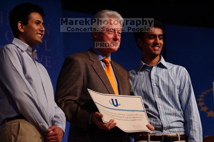 Former President Bill Clinton hands out commitment certificates to CGIU attendees for their exceptional pledges to the CGI cause during the opening plenary session of the CGIU meeting.  Day one of the 2nd Annual Clinton Global Initiative University (CGIU) meeting was held at The University of Texas at Austin, Friday, February 13, 2009.

Filename: SRM_20090213_16430192.jpg
Aperture: f/4.0
Shutter Speed: 1/250
Body: Canon EOS-1D Mark II
Lens: Canon EF 80-200mm f/2.8 L