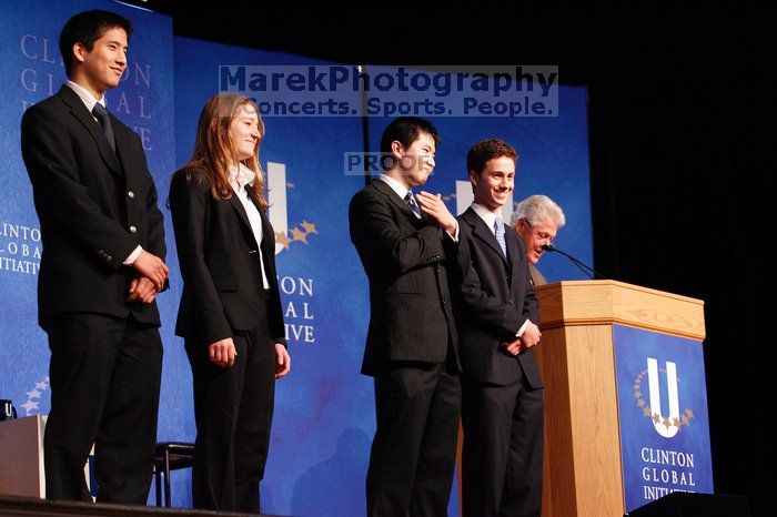 Former President Bill Clinton hands out commitment certificates to CGIU attendees for their exceptional pledges to the CGI cause during the opening plenary session of the CGIU meeting.  Day one of the 2nd Annual Clinton Global Initiative University (CGIU) meeting was held at The University of Texas at Austin, Friday, February 13, 2009.

Filename: SRM_20090213_16434296.jpg
Aperture: f/4.0
Shutter Speed: 1/100
Body: Canon EOS-1D Mark II
Lens: Canon EF 80-200mm f/2.8 L