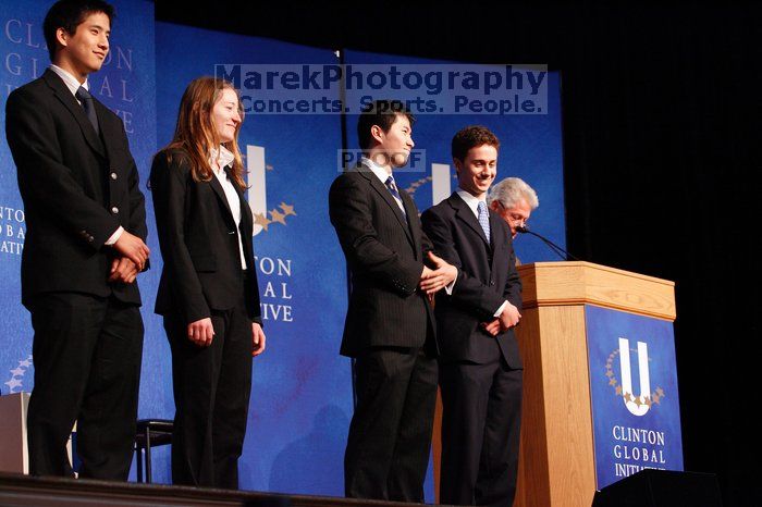 Former President Bill Clinton hands out commitment certificates to CGIU attendees for their exceptional pledges to the CGI cause during the opening plenary session of the CGIU meeting.  Day one of the 2nd Annual Clinton Global Initiative University (CGIU) meeting was held at The University of Texas at Austin, Friday, February 13, 2009.

Filename: SRM_20090213_16434298.jpg
Aperture: f/4.0
Shutter Speed: 1/100
Body: Canon EOS-1D Mark II
Lens: Canon EF 80-200mm f/2.8 L