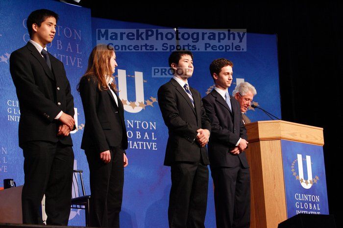 Former President Bill Clinton hands out commitment certificates to CGIU attendees for their exceptional pledges to the CGI cause during the opening plenary session of the CGIU meeting.  Day one of the 2nd Annual Clinton Global Initiative University (CGIU) meeting was held at The University of Texas at Austin, Friday, February 13, 2009.

Filename: SRM_20090213_16435202.jpg
Aperture: f/4.0
Shutter Speed: 1/100
Body: Canon EOS-1D Mark II
Lens: Canon EF 80-200mm f/2.8 L