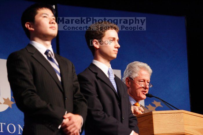 Former President Bill Clinton hands out commitment certificates to CGIU attendees for their exceptional pledges to the CGI cause during the opening plenary session of the CGIU meeting.  Day one of the 2nd Annual Clinton Global Initiative University (CGIU) meeting was held at The University of Texas at Austin, Friday, February 13, 2009.

Filename: SRM_20090213_16471424.jpg
Aperture: f/4.0
Shutter Speed: 1/100
Body: Canon EOS-1D Mark II
Lens: Canon EF 80-200mm f/2.8 L