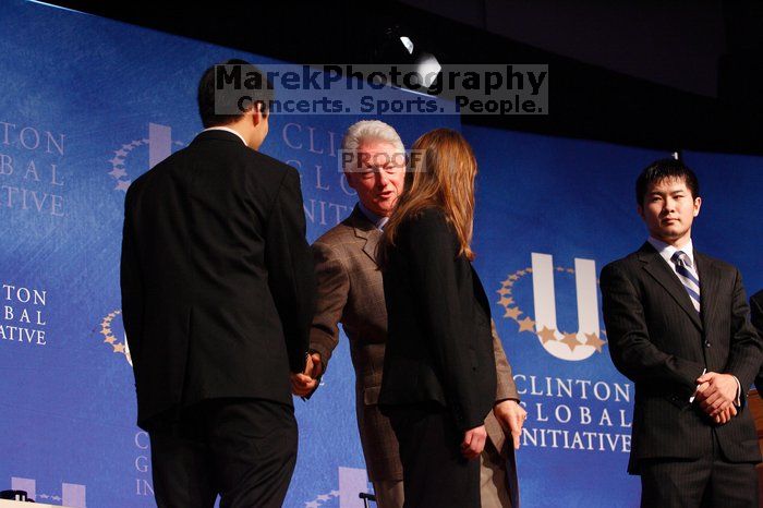 Former President Bill Clinton hands out commitment certificates to CGIU attendees for their exceptional pledges to the CGI cause during the opening plenary session of the CGIU meeting.  Day one of the 2nd Annual Clinton Global Initiative University (CGIU) meeting was held at The University of Texas at Austin, Friday, February 13, 2009.

Filename: SRM_20090213_16472728.jpg
Aperture: f/4.0
Shutter Speed: 1/100
Body: Canon EOS-1D Mark II
Lens: Canon EF 80-200mm f/2.8 L