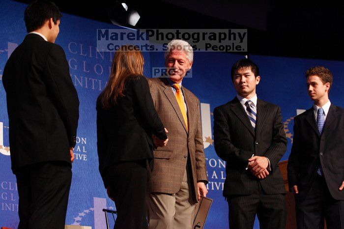 Former President Bill Clinton hands out commitment certificates to CGIU attendees for their exceptional pledges to the CGI cause during the opening plenary session of the CGIU meeting.  Day one of the 2nd Annual Clinton Global Initiative University (CGIU) meeting was held at The University of Texas at Austin, Friday, February 13, 2009.

Filename: SRM_20090213_16472830.jpg
Aperture: f/4.0
Shutter Speed: 1/125
Body: Canon EOS-1D Mark II
Lens: Canon EF 80-200mm f/2.8 L