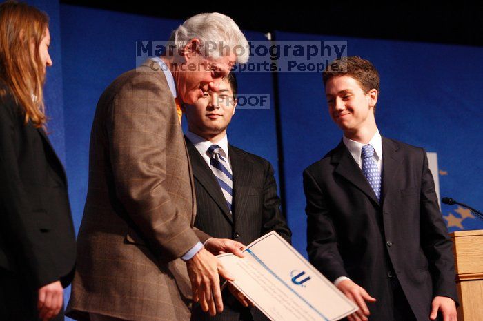 Former President Bill Clinton hands out commitment certificates to CGIU attendees for their exceptional pledges to the CGI cause during the opening plenary session of the CGIU meeting.  Day one of the 2nd Annual Clinton Global Initiative University (CGIU) meeting was held at The University of Texas at Austin, Friday, February 13, 2009.

Filename: SRM_20090213_16473234.jpg
Aperture: f/4.0
Shutter Speed: 1/100
Body: Canon EOS-1D Mark II
Lens: Canon EF 80-200mm f/2.8 L