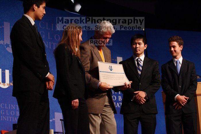 Former President Bill Clinton hands out commitment certificates to CGIU attendees for their exceptional pledges to the CGI cause during the opening plenary session of the CGIU meeting.  Day one of the 2nd Annual Clinton Global Initiative University (CGIU) meeting was held at The University of Texas at Austin, Friday, February 13, 2009.

Filename: SRM_20090213_16473336.jpg
Aperture: f/4.0
Shutter Speed: 1/160
Body: Canon EOS-1D Mark II
Lens: Canon EF 80-200mm f/2.8 L