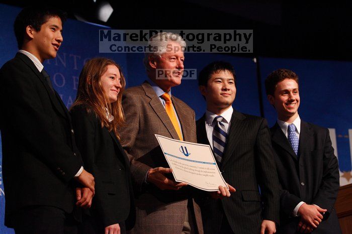 Former President Bill Clinton hands out commitment certificates to CGIU attendees for their exceptional pledges to the CGI cause during the opening plenary session of the CGIU meeting.  Day one of the 2nd Annual Clinton Global Initiative University (CGIU) meeting was held at The University of Texas at Austin, Friday, February 13, 2009.

Filename: SRM_20090213_16473640.jpg
Aperture: f/4.0
Shutter Speed: 1/200
Body: Canon EOS-1D Mark II
Lens: Canon EF 80-200mm f/2.8 L