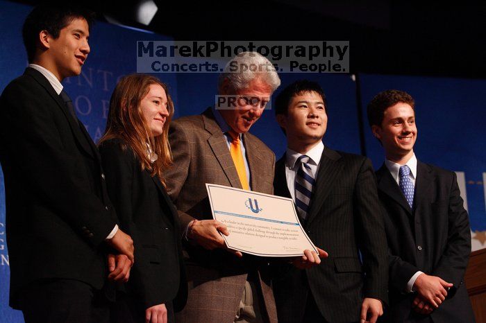 Former President Bill Clinton hands out commitment certificates to CGIU attendees for their exceptional pledges to the CGI cause during the opening plenary session of the CGIU meeting.  Day one of the 2nd Annual Clinton Global Initiative University (CGIU) meeting was held at The University of Texas at Austin, Friday, February 13, 2009.

Filename: SRM_20090213_16473742.jpg
Aperture: f/4.0
Shutter Speed: 1/200
Body: Canon EOS-1D Mark II
Lens: Canon EF 80-200mm f/2.8 L