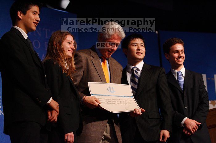 Former President Bill Clinton hands out commitment certificates to CGIU attendees for their exceptional pledges to the CGI cause during the opening plenary session of the CGIU meeting.  Day one of the 2nd Annual Clinton Global Initiative University (CGIU) meeting was held at The University of Texas at Austin, Friday, February 13, 2009.

Filename: SRM_20090213_16473743.jpg
Aperture: f/4.0
Shutter Speed: 1/200
Body: Canon EOS-1D Mark II
Lens: Canon EF 80-200mm f/2.8 L