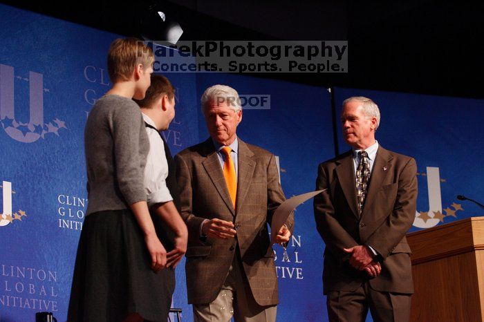 Former President Bill Clinton hands out commitment certificates to CGIU attendees for their exceptional pledges to the CGI cause during the opening plenary session of the CGIU meeting.  Day one of the 2nd Annual Clinton Global Initiative University (CGIU) meeting was held at The University of Texas at Austin, Friday, February 13, 2009.

Filename: SRM_20090213_16504771.jpg
Aperture: f/4.0
Shutter Speed: 1/160
Body: Canon EOS-1D Mark II
Lens: Canon EF 80-200mm f/2.8 L