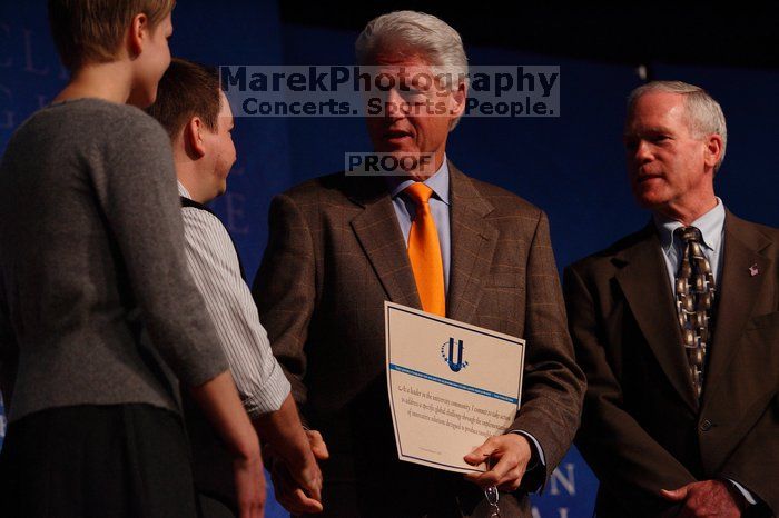 Former President Bill Clinton hands out commitment certificates to CGIU attendees for their exceptional pledges to the CGI cause during the opening plenary session of the CGIU meeting.  Day one of the 2nd Annual Clinton Global Initiative University (CGIU) meeting was held at The University of Texas at Austin, Friday, February 13, 2009.

Filename: SRM_20090213_16504875.jpg
Aperture: f/4.0
Shutter Speed: 1/320
Body: Canon EOS-1D Mark II
Lens: Canon EF 80-200mm f/2.8 L