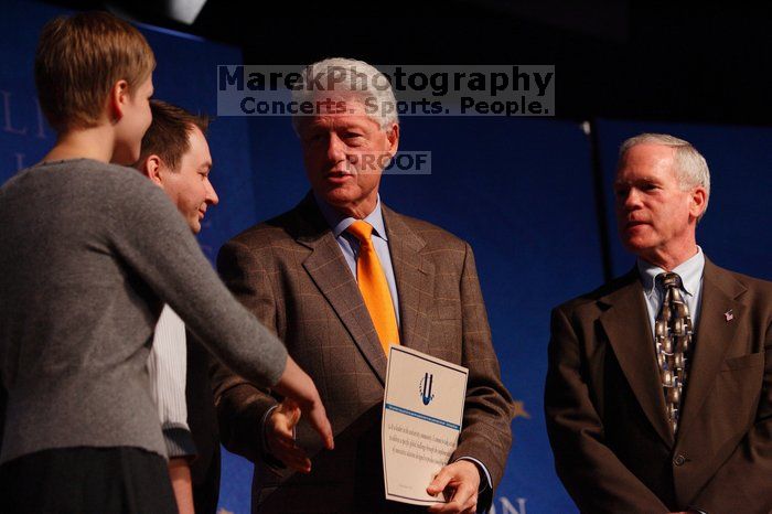 Former President Bill Clinton hands out commitment certificates to CGIU attendees for their exceptional pledges to the CGI cause during the opening plenary session of the CGIU meeting.  Day one of the 2nd Annual Clinton Global Initiative University (CGIU) meeting was held at The University of Texas at Austin, Friday, February 13, 2009.

Filename: SRM_20090213_16504876.jpg
Aperture: f/4.0
Shutter Speed: 1/200
Body: Canon EOS-1D Mark II
Lens: Canon EF 80-200mm f/2.8 L