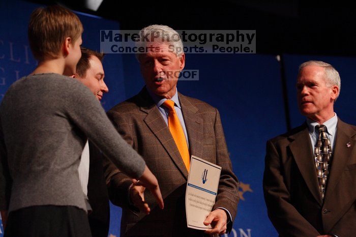 Former President Bill Clinton hands out commitment certificates to CGIU attendees for their exceptional pledges to the CGI cause during the opening plenary session of the CGIU meeting.  Day one of the 2nd Annual Clinton Global Initiative University (CGIU) meeting was held at The University of Texas at Austin, Friday, February 13, 2009.

Filename: SRM_20090213_16504977.jpg
Aperture: f/4.0
Shutter Speed: 1/200
Body: Canon EOS-1D Mark II
Lens: Canon EF 80-200mm f/2.8 L