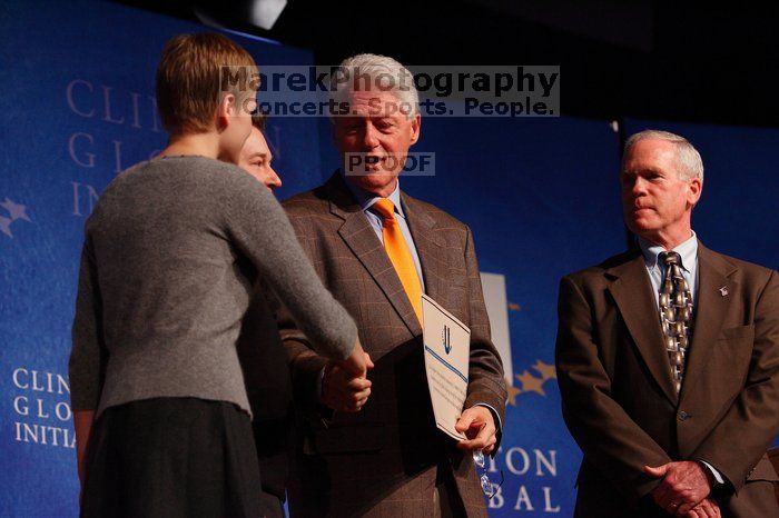 Former President Bill Clinton hands out commitment certificates to CGIU attendees for their exceptional pledges to the CGI cause during the opening plenary session of the CGIU meeting.  Day one of the 2nd Annual Clinton Global Initiative University (CGIU) meeting was held at The University of Texas at Austin, Friday, February 13, 2009.

Filename: SRM_20090213_16504980.jpg
Aperture: f/4.0
Shutter Speed: 1/200
Body: Canon EOS-1D Mark II
Lens: Canon EF 80-200mm f/2.8 L