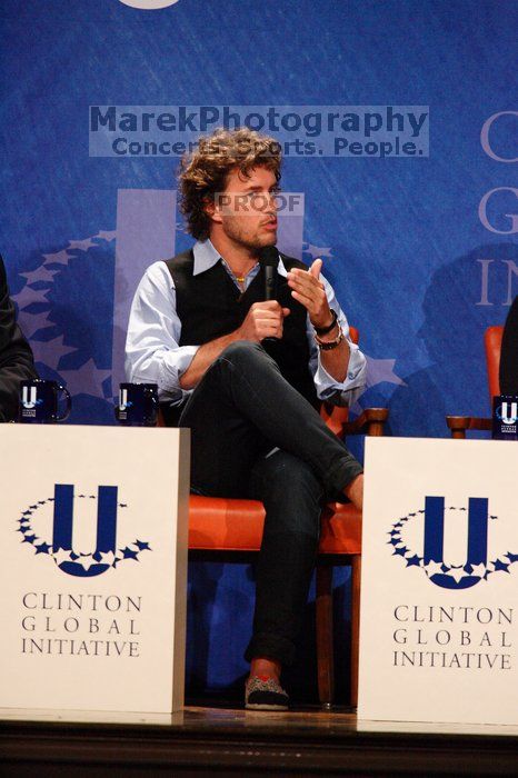 Blake Mycoskie, founder of TOMS shoes, donates one pair of shoes to a third world country for every pair of shoes they sell.  Day one of the 2nd Annual Clinton Global Initiative University (CGIU) meeting was held at The University of Texas at Austin, Friday, February 13, 2009.

Filename: SRM_20090213_17125775.jpg
Aperture: f/5.6
Shutter Speed: 1/250
Body: Canon EOS-1D Mark II
Lens: Canon EF 300mm f/2.8 L IS