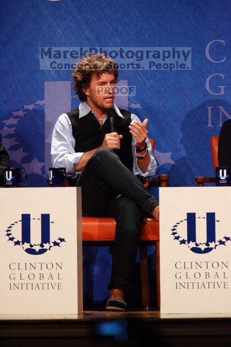 Blake Mycoskie, founder of TOMS shoes, donates one pair of shoes to a third world country for every pair of shoes they sell.  Day one of the 2nd Annual Clinton Global Initiative University (CGIU) meeting was held at The University of Texas at Austin, Friday, February 13, 2009.

Filename: SRM_20090213_17131477.jpg
Aperture: f/5.6
Shutter Speed: 1/250
Body: Canon EOS-1D Mark II
Lens: Canon EF 300mm f/2.8 L IS