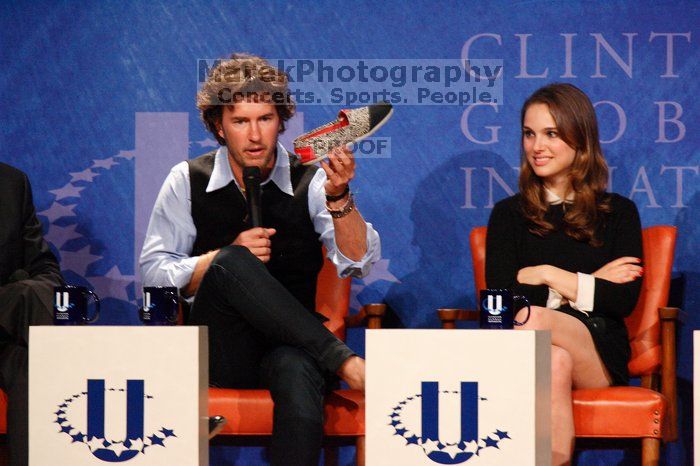 Blake Mycoskie (L), founder of TOMS shoes, holds up a pair of TOMS, with Natalie Portman (R) at the first plenary session of the CGIU meeting.  Day one of the 2nd Annual Clinton Global Initiative University (CGIU) meeting was held at The University of Texas at Austin, Friday, February 13, 2009.

Filename: SRM_20090213_17150501.jpg
Aperture: f/5.6
Shutter Speed: 1/200
Body: Canon EOS-1D Mark II
Lens: Canon EF 300mm f/2.8 L IS