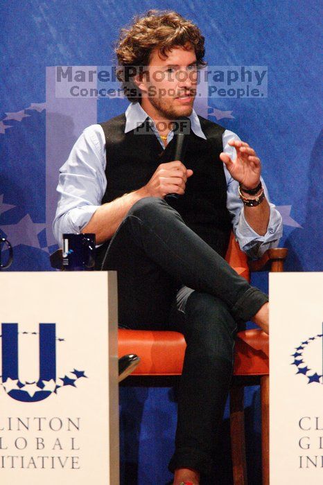 Blake Mycoskie, founder of TOMS shoes, donates one pair of shoes to a third world country for every pair of shoes they sell.  Day one of the 2nd Annual Clinton Global Initiative University (CGIU) meeting was held at The University of Texas at Austin, Friday, February 13, 2009.

Filename: SRM_20090213_17180731.jpg
Aperture: f/5.6
Shutter Speed: 1/200
Body: Canon EOS-1D Mark II
Lens: Canon EF 300mm f/2.8 L IS