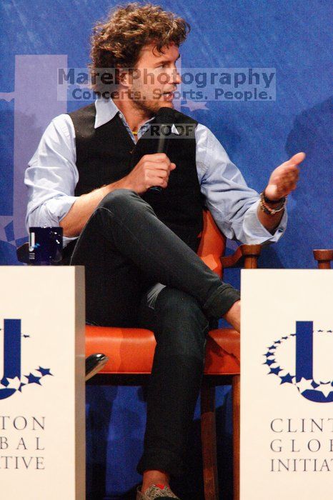 Blake Mycoskie, founder of TOMS shoes, donates one pair of shoes to a third world country for every pair of shoes they sell.  Day one of the 2nd Annual Clinton Global Initiative University (CGIU) meeting was held at The University of Texas at Austin, Friday, February 13, 2009.

Filename: SRM_20090213_17183037.jpg
Aperture: f/5.6
Shutter Speed: 1/160
Body: Canon EOS-1D Mark II
Lens: Canon EF 300mm f/2.8 L IS