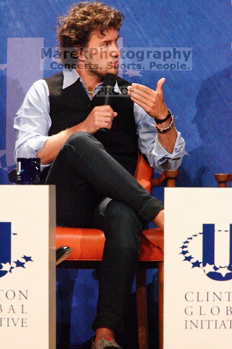 Blake Mycoskie, founder of TOMS shoes, donates one pair of shoes to a third world country for every pair of shoes they sell.  Day one of the 2nd Annual Clinton Global Initiative University (CGIU) meeting was held at The University of Texas at Austin, Friday, February 13, 2009.

Filename: SRM_20090213_17183038.jpg
Aperture: f/5.6
Shutter Speed: 1/160
Body: Canon EOS-1D Mark II
Lens: Canon EF 300mm f/2.8 L IS