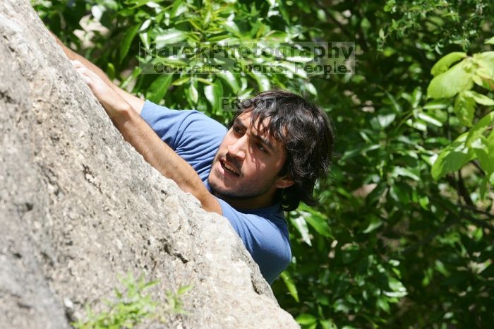 Javier Morales leading Nose Print on the Windshield (5.11c), shot from the top of Ack! (5.11b, but using the crack for the start instead) that I top roped up with my camera on my back.  It was another long day of rock climbing at Seismic Wall on Austin's Barton Creek Greenbelt, Sunday, April 5, 2009.

Filename: SRM_20090405_13321262.jpg
Aperture: f/8.0
Shutter Speed: 1/500
Body: Canon EOS-1D Mark II
Lens: Canon EF 80-200mm f/2.8 L