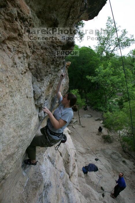 Hannah Norton top rope climbing Diving for Rocks (5.10d), photographed from  the third bolt of Magster (5.10a).  It was another long day of rock climbing at Seismic Wall on Austin's Barton Creek Greenbelt, Saturday, April 11, 2009.

Filename: SRM_20090411_16102848.JPG
Aperture: f/5.0
Shutter Speed: 1/250
Body: Canon EOS-1D Mark II
Lens: Canon EF 16-35mm f/2.8 L