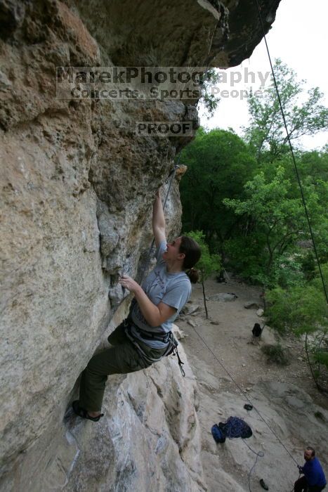 Hannah Norton top rope climbing Diving for Rocks (5.10d), photographed from  the third bolt of Magster (5.10a).  It was another long day of rock climbing at Seismic Wall on Austin's Barton Creek Greenbelt, Saturday, April 11, 2009.

Filename: SRM_20090411_16103153.JPG
Aperture: f/5.0
Shutter Speed: 1/250
Body: Canon EOS-1D Mark II
Lens: Canon EF 16-35mm f/2.8 L