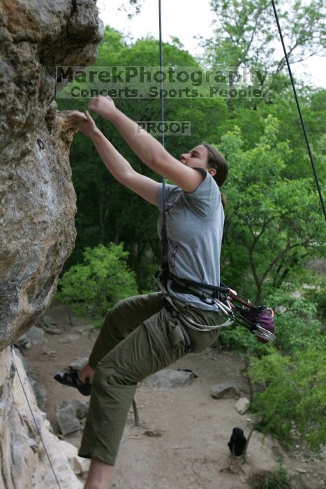 Hannah Norton top rope climbing Diving for Rocks (5.10d), photographed from  the third bolt of Magster (5.10a).  It was another long day of rock climbing at Seismic Wall on Austin's Barton Creek Greenbelt, Saturday, April 11, 2009.

Filename: SRM_20090411_16112362.JPG
Aperture: f/4.0
Shutter Speed: 1/250
Body: Canon EOS-1D Mark II
Lens: Canon EF 16-35mm f/2.8 L