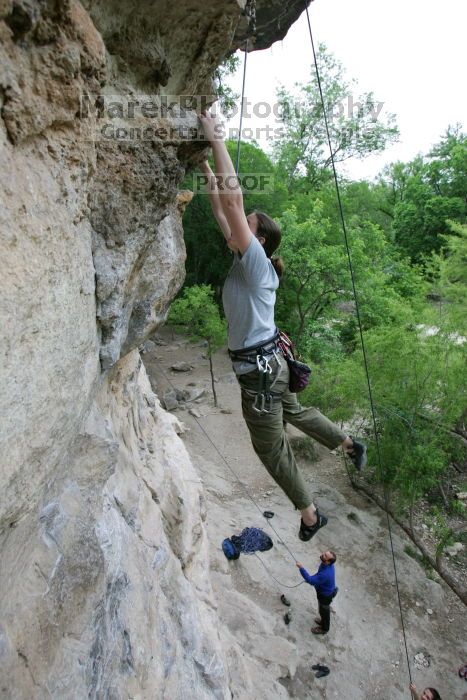 Hannah Norton top rope climbing Diving for Rocks (5.10d), photographed from  the third bolt of Magster (5.10a).  It was another long day of rock climbing at Seismic Wall on Austin's Barton Creek Greenbelt, Saturday, April 11, 2009.

Filename: SRM_20090411_16134170.JPG
Aperture: f/4.0
Shutter Speed: 1/250
Body: Canon EOS-1D Mark II
Lens: Canon EF 16-35mm f/2.8 L